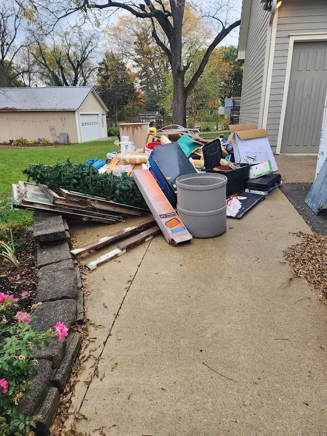 Dumpster being loaded with debris for Estate Cleanout Dumpster Rental in San Juan Capistrano